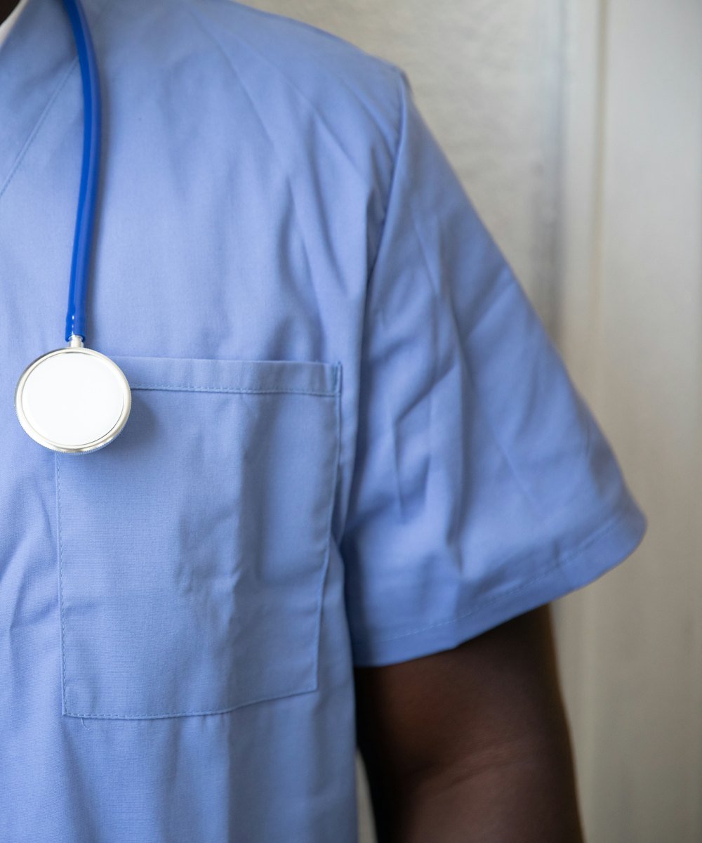 Healthcare worker in scrubs with a stethoscope